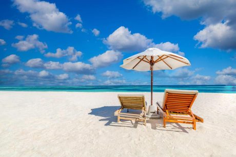tranquil-beach-scene-couple-chairs-umbrella-exotic-tropical-beach-landscape-destination-for-background-or-wallpaper-design-of-romantic-summer-vacation-holiday-concept-photo
